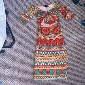 A short sleeve dress with versatile styling options in the shoulder area.